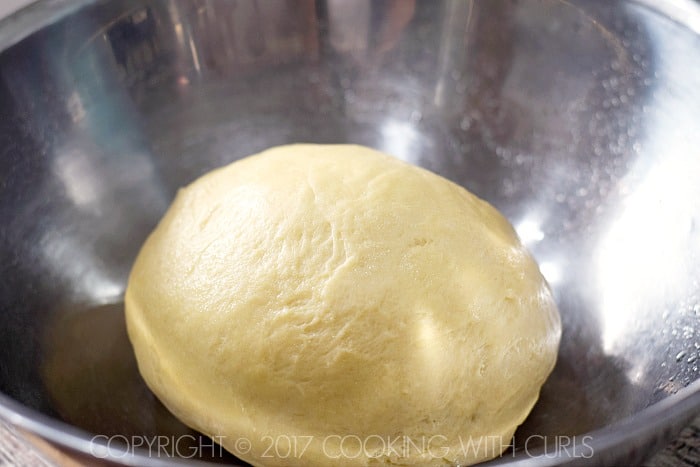 Dough ball in a large, oiled bowl.