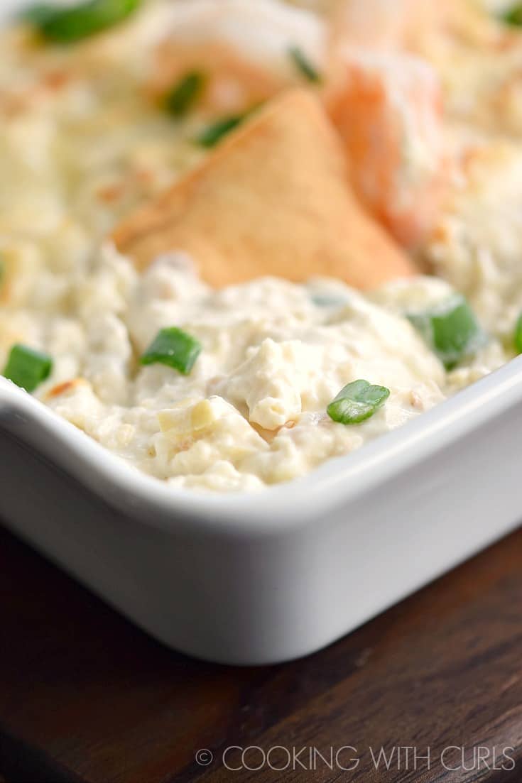 Simple Seafood Artichoke Dip in a white baking dish.