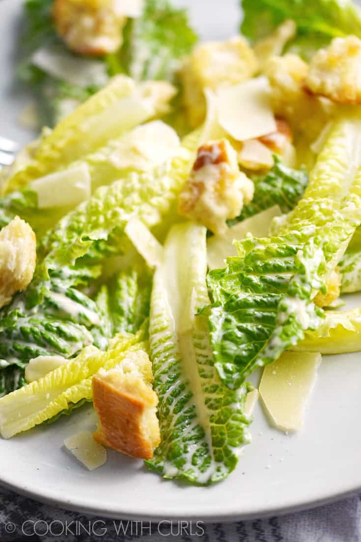 Classic Caesar Salad with romaine hearts, Caesar salad dressing, shaved Parmesan and homemade garlic croutons is the perfect start to any meal! © COOKING WITH CURLS