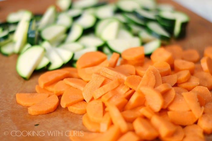 Cutting board with sliced carrots and zucchini