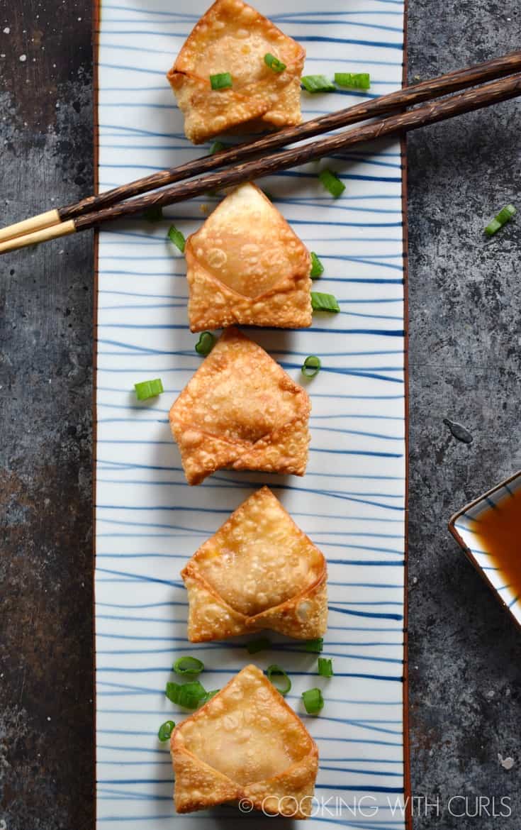 These Crispy Pork Wontons with Sweet and Sour Dipping Sauce are the perfect start to your meal or as a party appetizer! © COOKING WITH CURLS