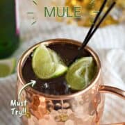 Irish Mule in a copper mug with lime wedges and bottle of whiskey and ginger beer in the background and title graphic across the top.