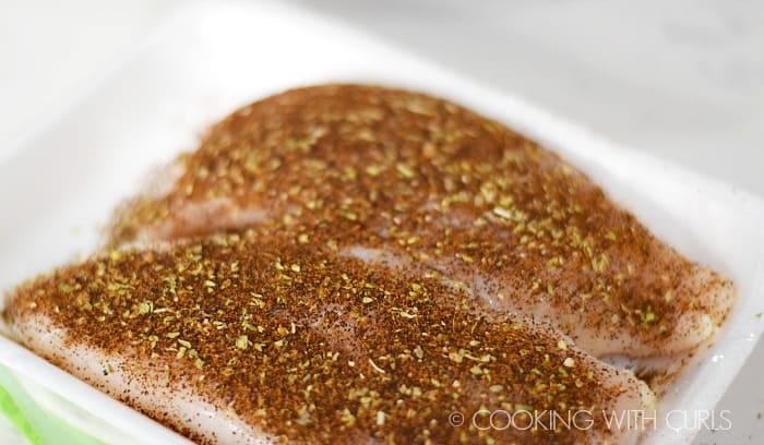 Season the chicken breasts with seasoning mix.