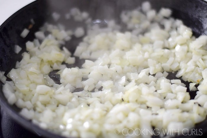 Saute chopped onions in a skillet © COOKING WITH CURLS