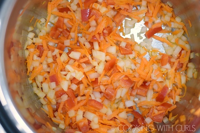 Sauté the onions, bell pepper and shredded carrots in the Instant Pot.