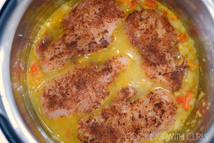 Saluted vegetables with chicken breasts and chicken stock.