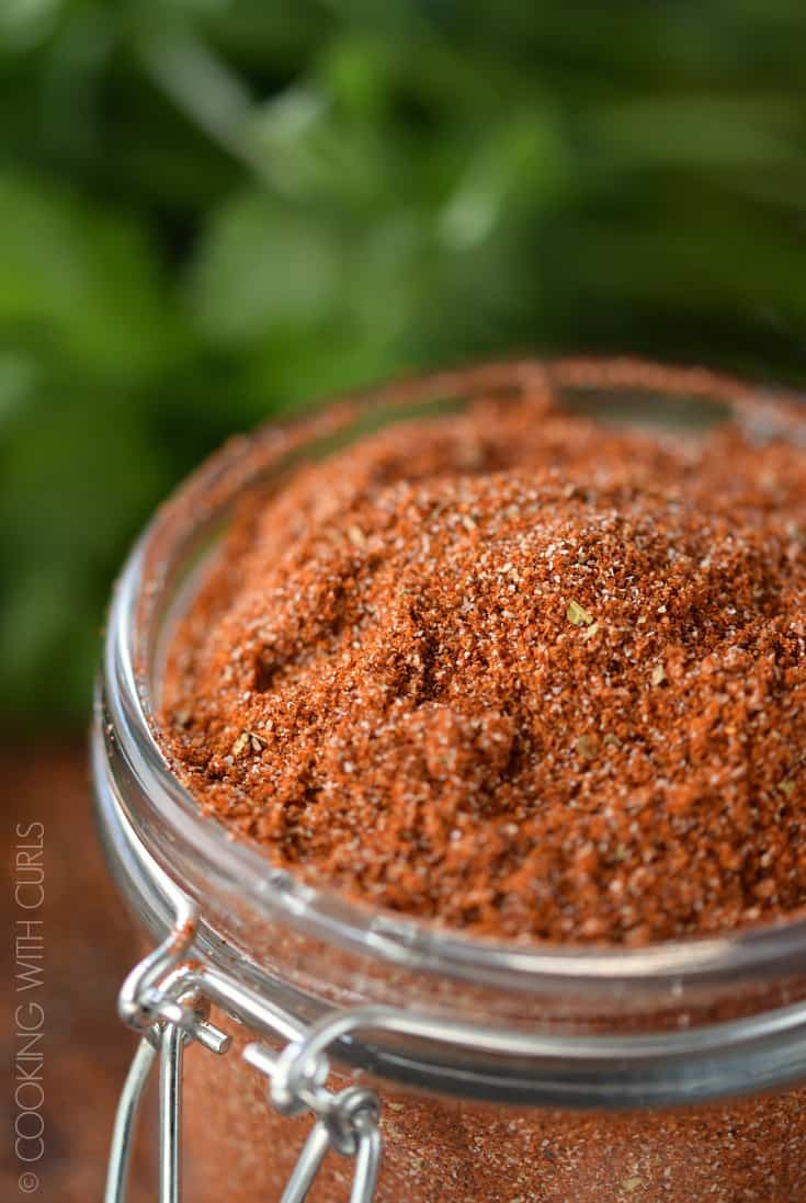 A close-up mage of Mexican spices blended together in a small glass jar.
