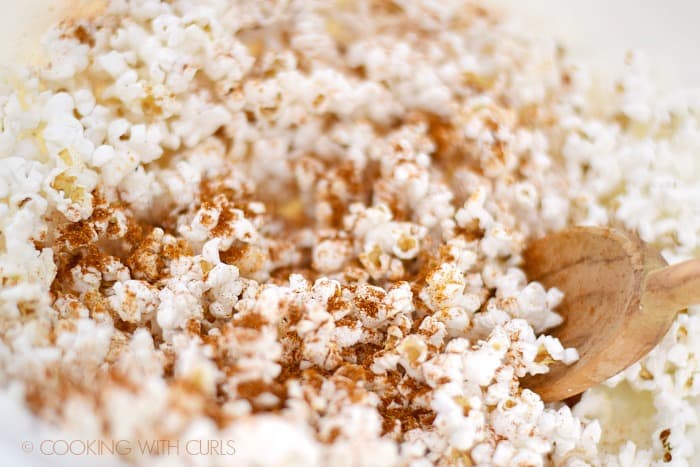 Toss the Taco Popcorn together in a large bowl with a wooden spoon © COOKING WITH CURLS