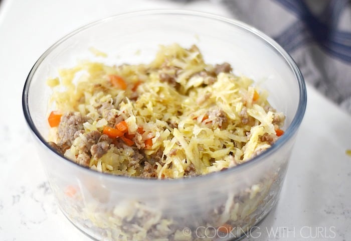 Glass baking dish with the browned sausage, onion, pepper, and hash browns © COOKING WITH CURLS