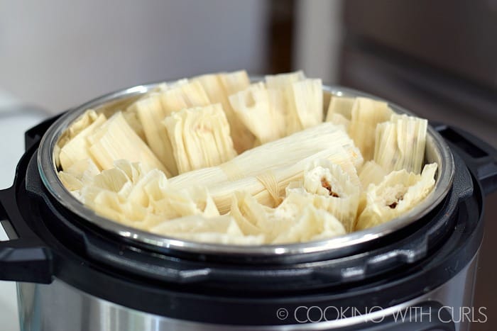 Place wrapped tamales into the Instant Pot with a steamer basket © COOKING WITH CURLS
