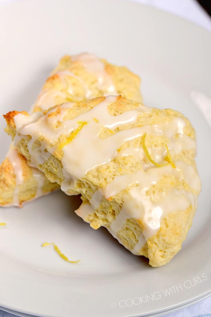 Two Glazed Lemon Scones stacked on a small plate.