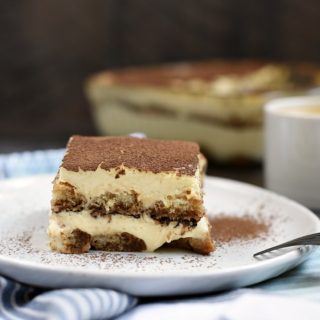 Classic Tiramisu with coffee soaked ladyfingers, creamy filling, and a big dose of cocoa powder! © COOKING WITH CURLS
