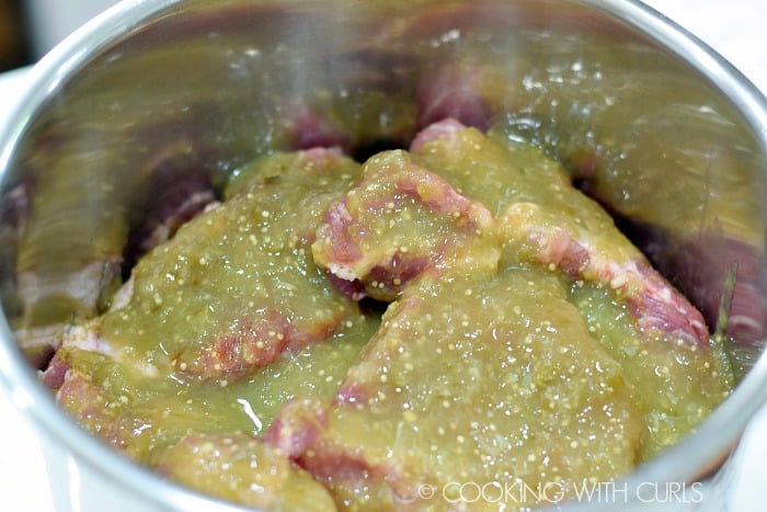 Cover seasoned pork with additional salsa verde © COOKING WITH CURLS