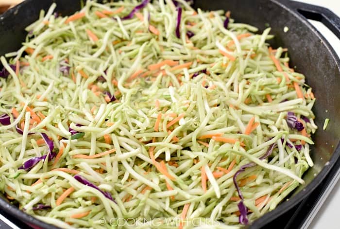 Heat the broccoli slaw in a large skillet until it starts to wilt © COOKING WITH CURLS