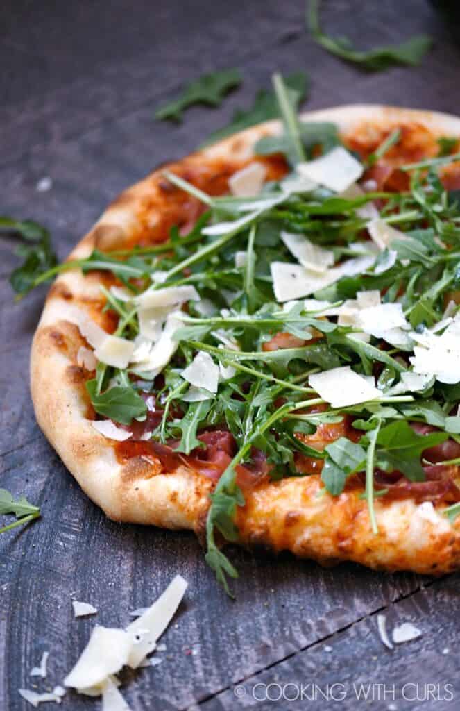 ProsciuttoArugula Pizza Cooking with Curls