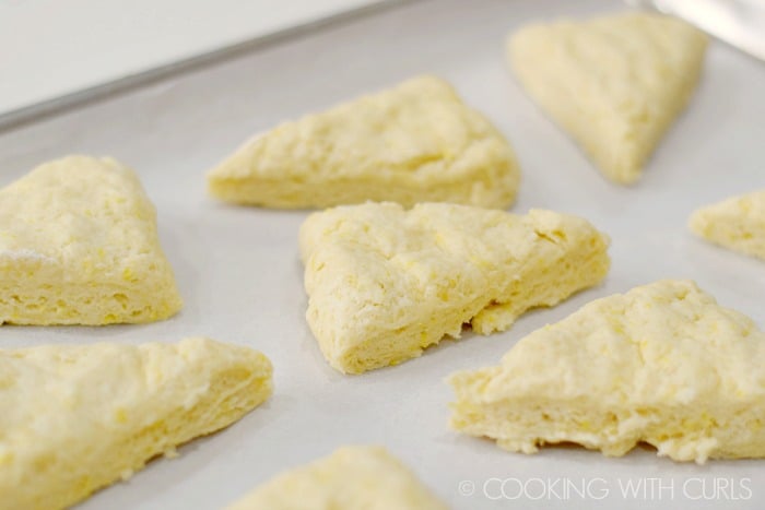 Place scones wedges on a parchment lined baking sheet © COOKING WITH CURLS