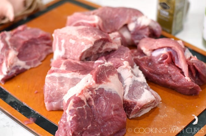 Remove the bone from the pork shoulder and cut into large chunks © COOKING WITH CURLS