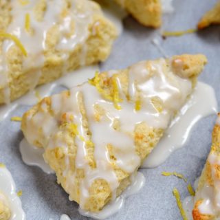 These light and flaky Glazed Lemon Scones are bursting with lemony flavor and topped with a sweet sugar glaze! © COOKING WITH CURLS