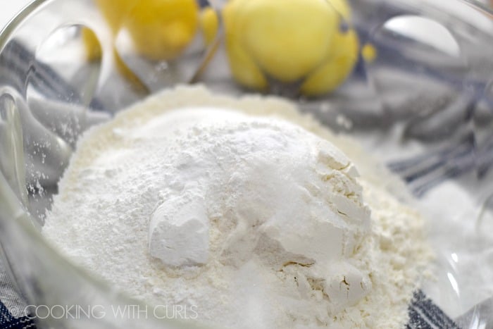 Flour, sugar, baking powder, baking soda, salt, and lemon zest in a large mixing bowl.