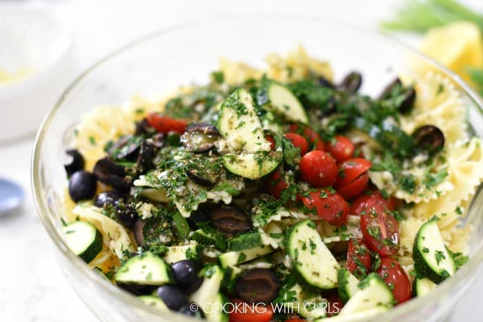 Toss the pasta and vegetables with the dressing in a large bowl © COOKING WITH CURLS