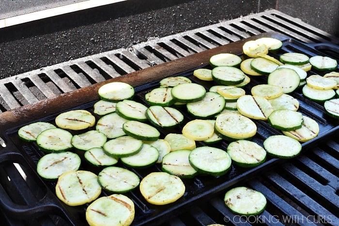 Slices of zucchini and summer squash on a cast iron grill pan.