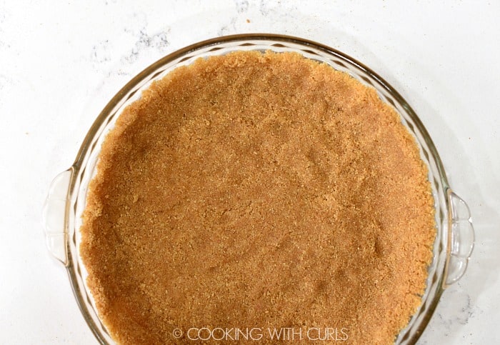 Press the graham crumb mixture evenly into a pie plate © COOKING WITH CURLS