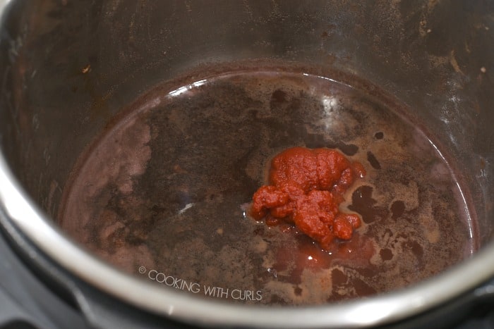 Add the wine beef stock and tomato paste to the pot.