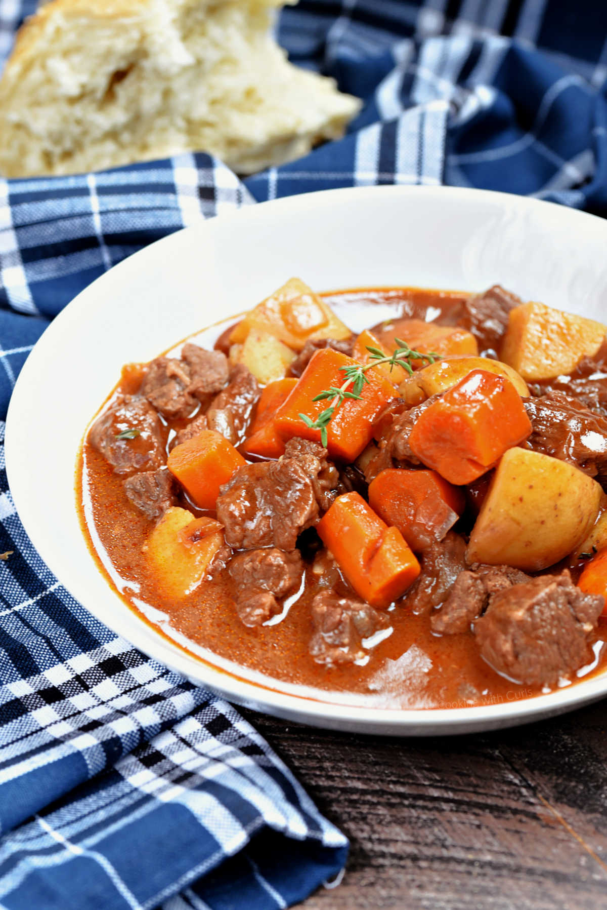 Instant pot beef stew with potatoes, carrots, and gravy in a bowl.