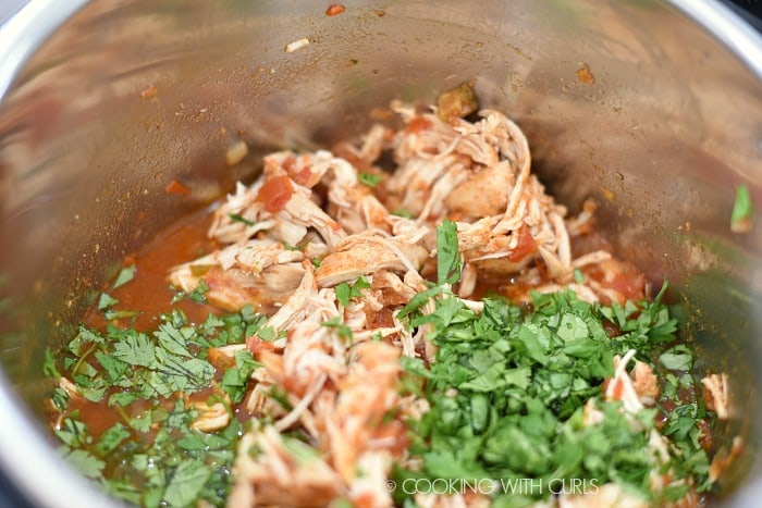 Mix the shredded chicken with the cilantro and lime juice in the pressure cooker.