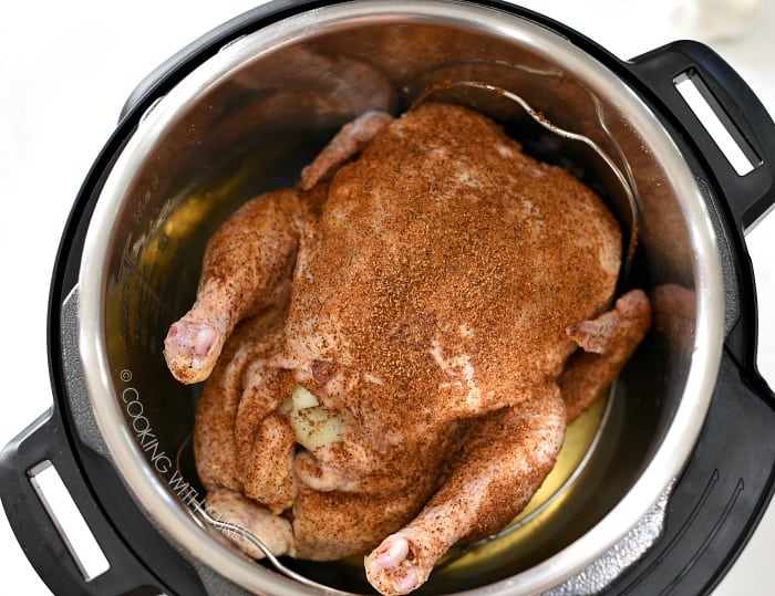 Place the whole seasoned chicken on a trivet in the pressure cooker cookingwithcurls.com