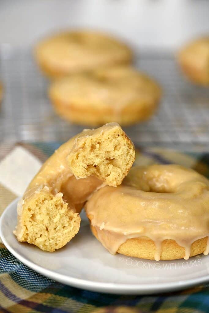 These Maple Glazed Donuts are baked, not fried, and topped with a sweet, buttery glaze for an amazing treat the whole family will love! cookingwithcurls.com