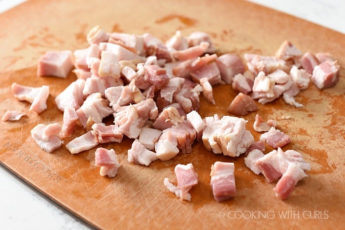 Thick cut bacon chopped up on a cutting board cookingwithcurls.com