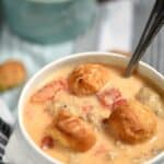 This thick and creamy Beer Brats and Cheese Chowder is loaded with flavor and topped with soft pretzel bites, perfect for a cold winter night! cookingwithcurls.com