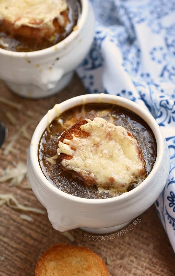 Instant Pot French Onion Soup topped with melted cheese bread.
