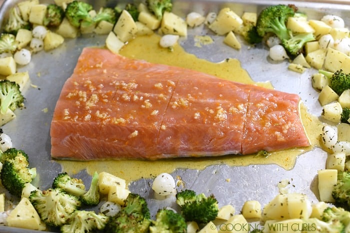 Push the vegetables to the side and place the glazed salmon in the center of the baking sheet cookingwithcurls.com