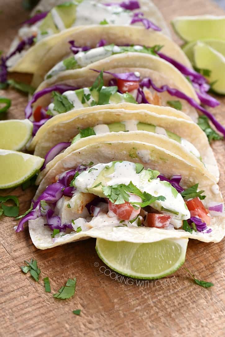 Tender cod is seasoned and baked to perfection, then wrapped in warm tortillas and topped with your favorite toppings to create the best Fish Tacos around! cookingwithcurls.com