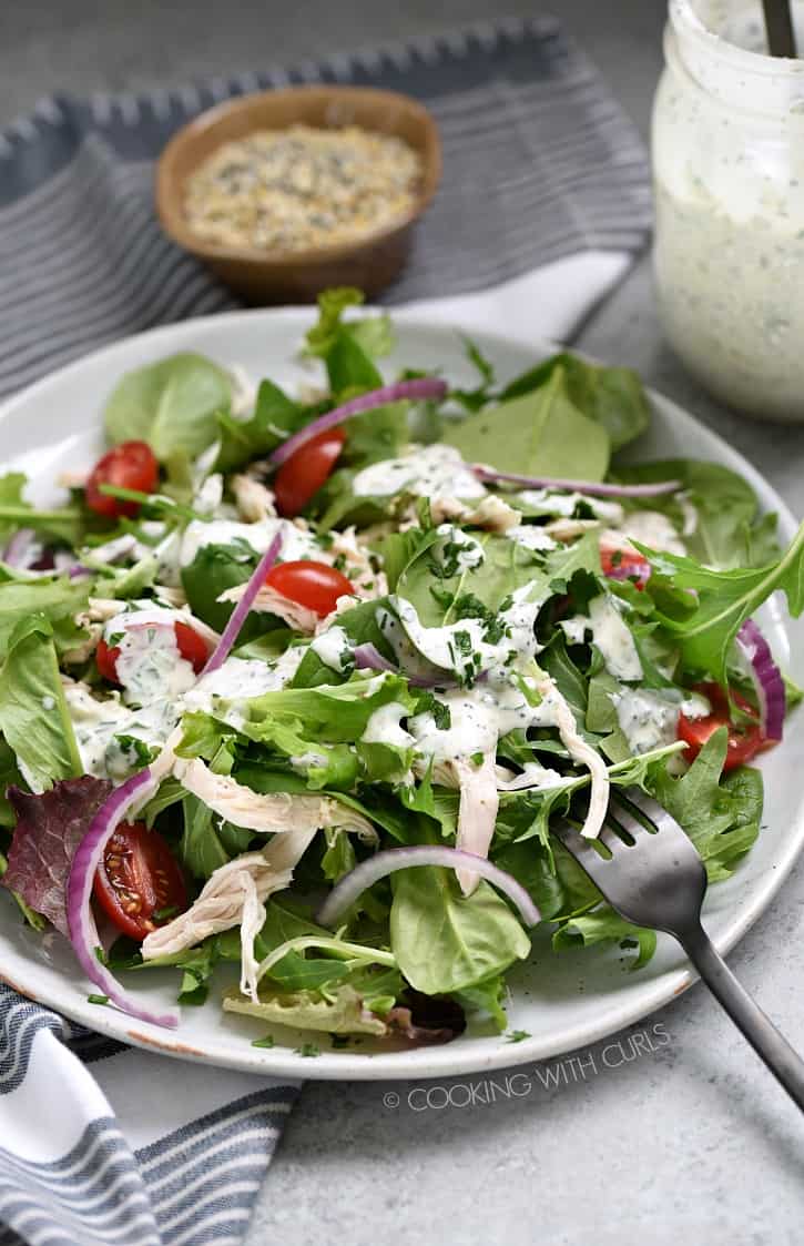 A spring greens salad topped with Everything Bagel Ranch Dressing! cookingwithcurls.com