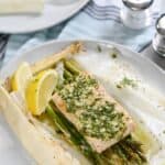 Baked Salmon in Parchment with Asparagus Lemon and Dill is an impressive meal that is simple to prepare! cookingwithcurls.com