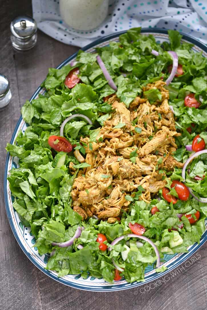 Everyone in the family will love this Chicken Shawarma Salad. It is loaded with Mediterranean flavors and topped with a tzatziki dressing! cookingwithcurls.com