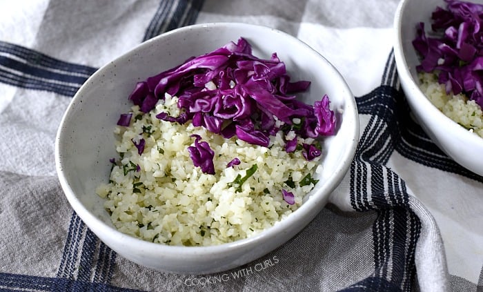 Cauliflower rice and shredded cabbage in a bowl.