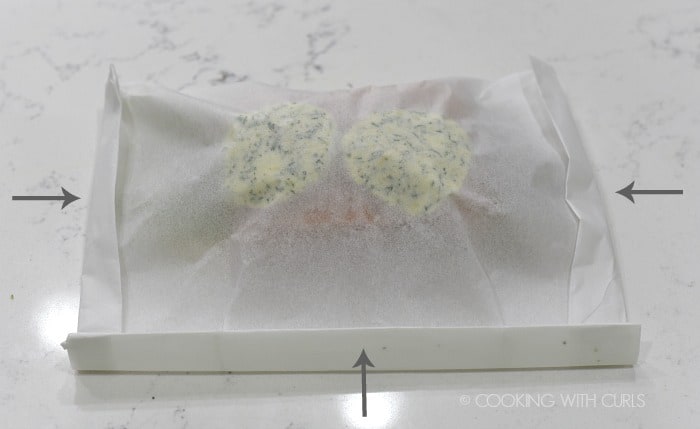 Wrap the folded parchment paper around the salmon, and fold over the edges to create a pouch cookingwithcurls.com
