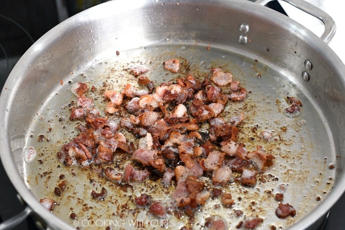 Crispy chopped bacon cooked in a large skillet 