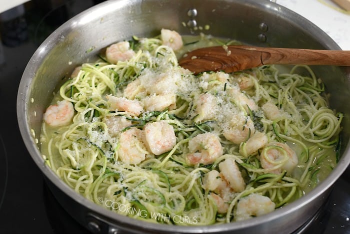 Zucchini noodles, cooked Shrimp and Parmesan cheese in a skillet.