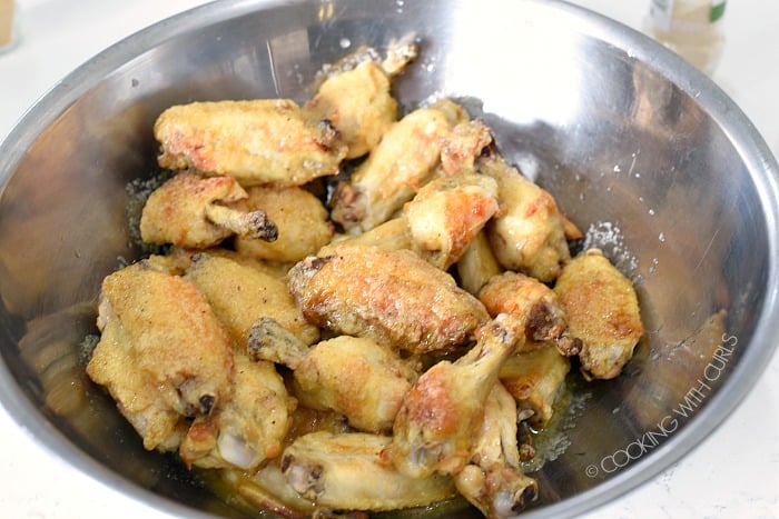 Toss the chicken wings with the garlic parmesan sauce to coat cookingwithcurls.com