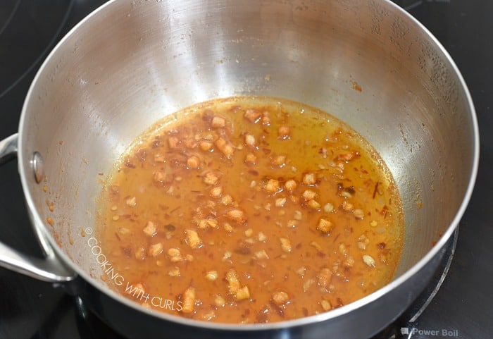 Reduced chili lime butter sauce in a saucepan