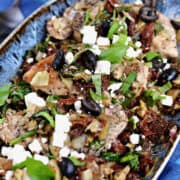 Chicken topped with sun-dried tomatoes, olives, artichoke, and feta cheese.