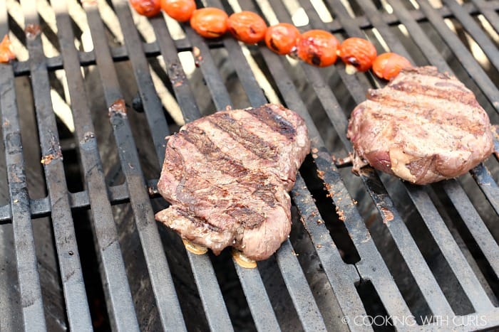 Grilled steaks and tomatoes on the grill 