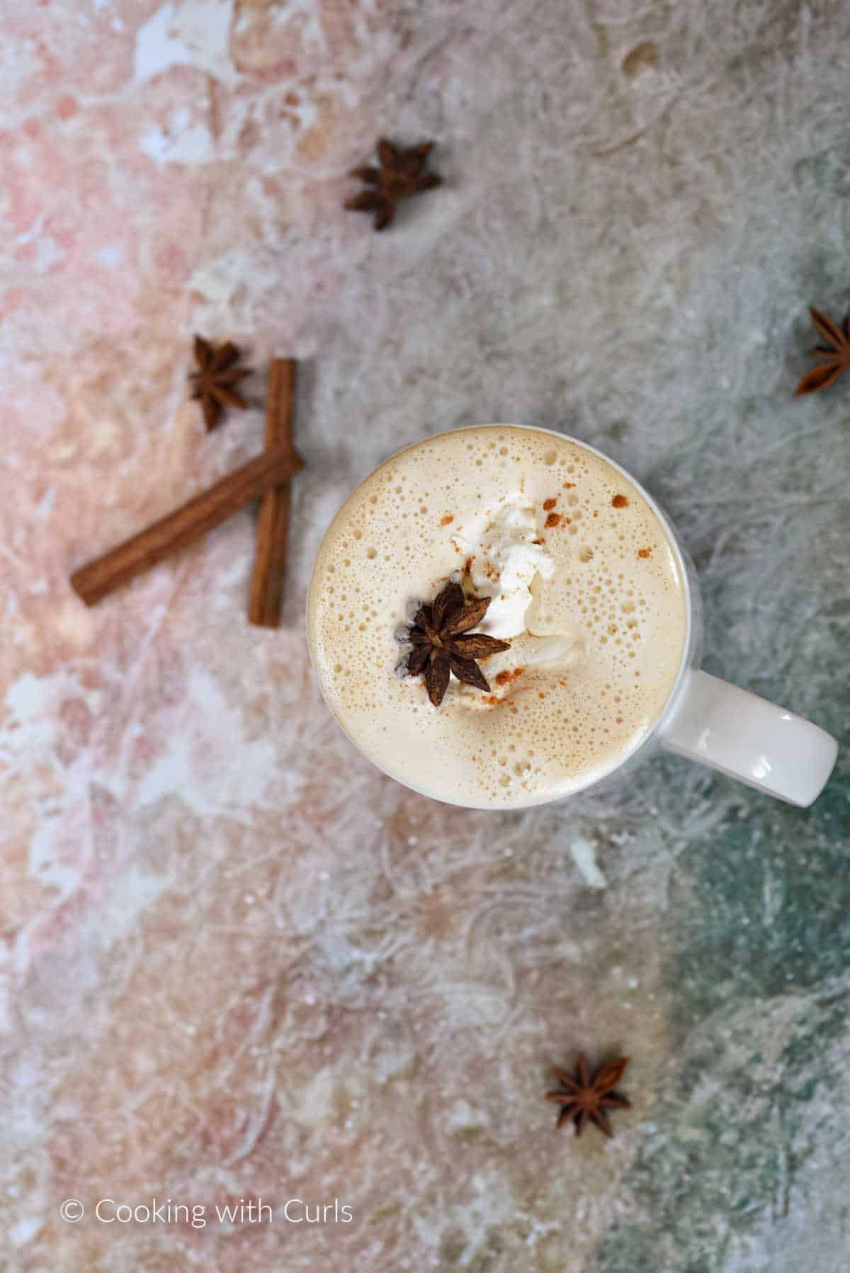 Looking down on a homemade pumpkin spice latte topped with whipped cream.