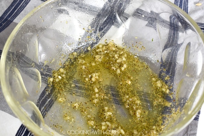 Olive oil, garlic, oregano and lemon zest in a large glass bowl 