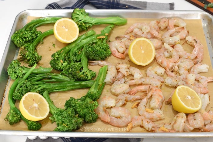Shrimp is added to the sheet pan with the partially cooked broccolini 